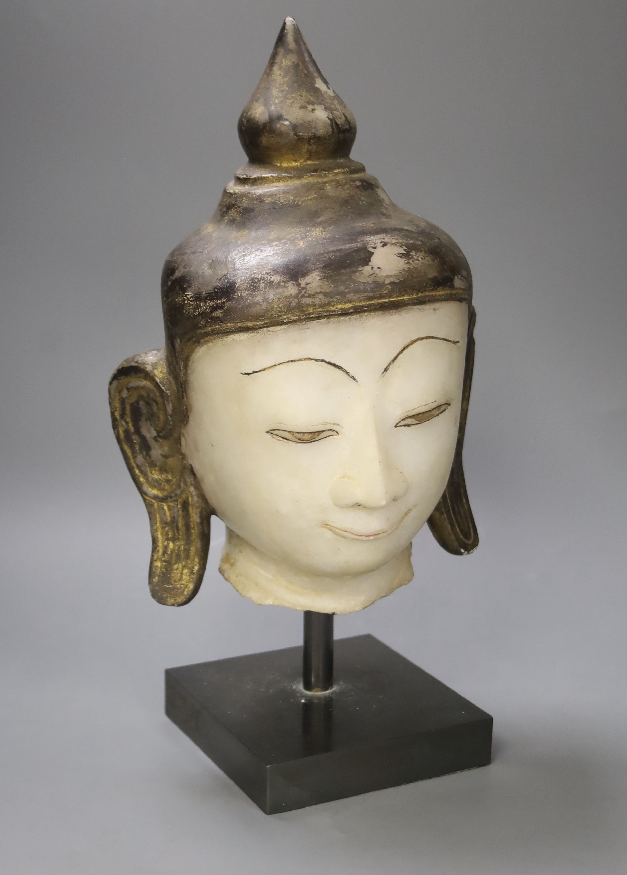 An 18th century Burmese white marble Shan-Style Buddha’s head, on stand, bought in 1995 in Burma or Myanmar, height 36cm